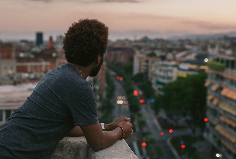 man looking out over the city