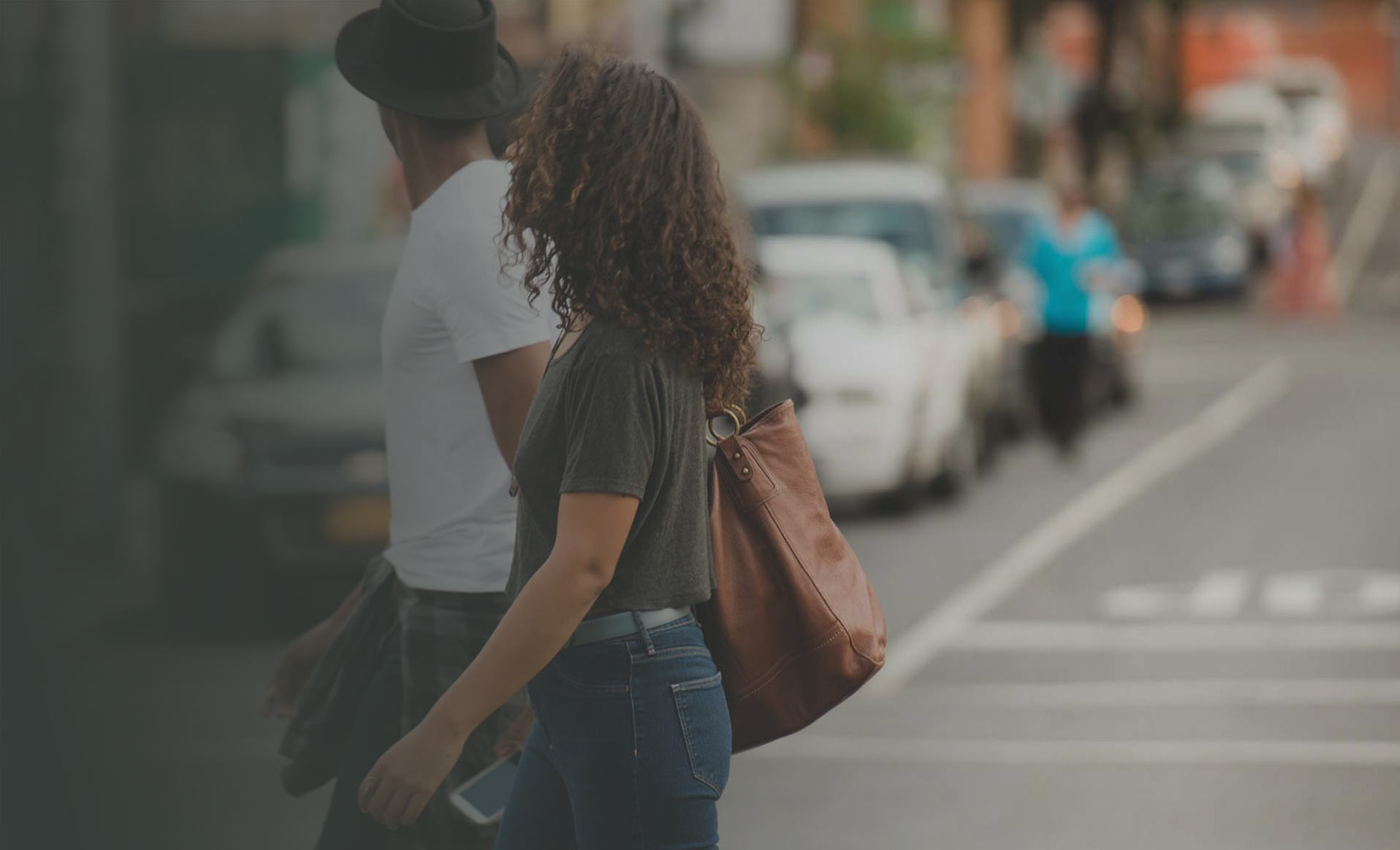 Young people drinking coffee and crossing the street